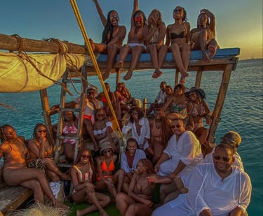 Traditional dhow sailing along Zanzibar’s coast during a stunning sunset, offering panoramic ocean views.