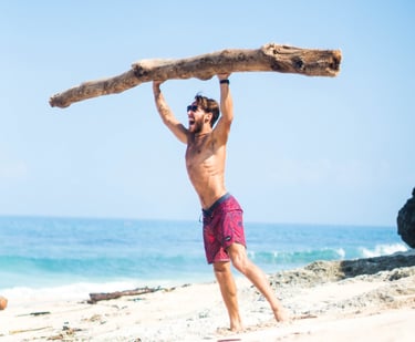 a strong man lifting a large heavy piece of wood in his hands