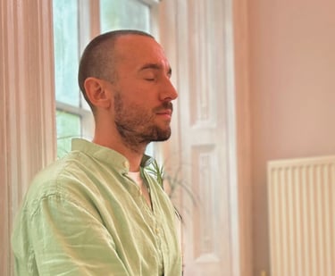 a man sitting with eyes closed meditating