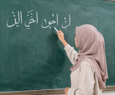 A professional female teacher in a green hijab guiding a student through Quranic recitation on a laptop screen.