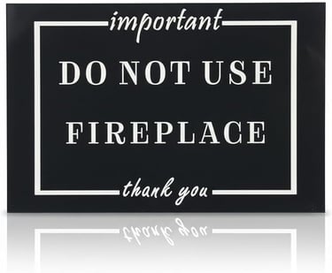 Black and white safety sign stating important do not use fireplace thank you