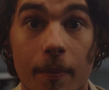 a man with a mustache and a tie on his neck