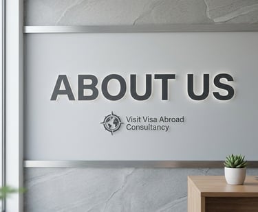 Modern office wall featuring the "About Us" sign and Visit Visa Abroad Consultancy logo.