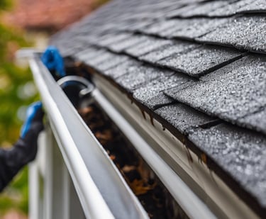 a man in a yellow vest is cleaning the floor