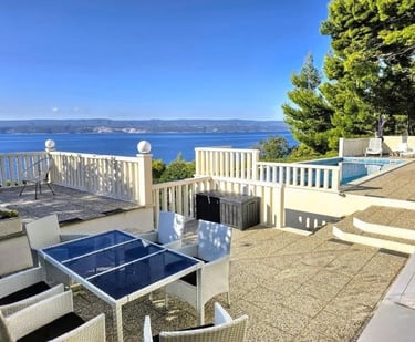 The photo depicts the courtard dining set as well as parts of the eastern sun terrace and pool.