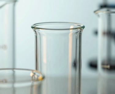 Clear glass test tube and beakers for scientific laboratory research and chemical experiments.