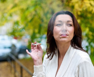 A middle-aged woman smoking a cigarette. Jenn Thongtan, Green Leaf Hypnotherapy, Lancing , UK