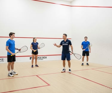 Squash coach teaching a group session