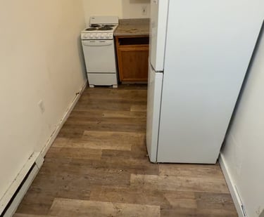 Crew removing old refrigerator during appliance removal service