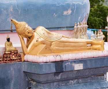 A detailed photo of a large, golden reclining Buddha statue at Wat Phra Yai Temple in Koh Samui