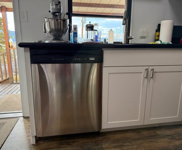 Frigidaire dishwasher installation by Cherry Home Service – modern kitchen setup with scenic mountai