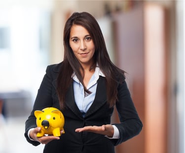 a woman in a suit and tie holding a piggy bank
