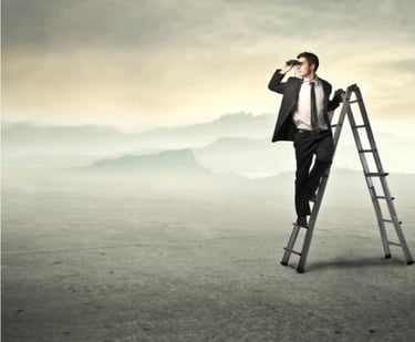 Man on a ladder looking through binoculars