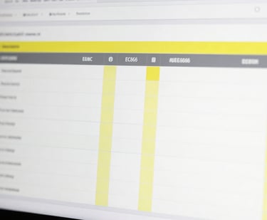 A minimalist photo of a digital compliance report on a sleek screen, showcasing clean columns and yellow #EBC86F success markers.