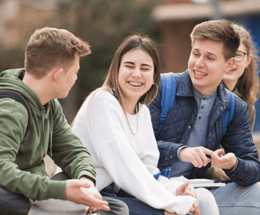 a group of young people sitting on a bench