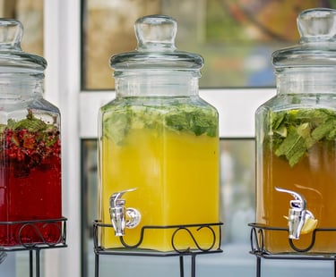 three jars of drinks in a row of three different colors