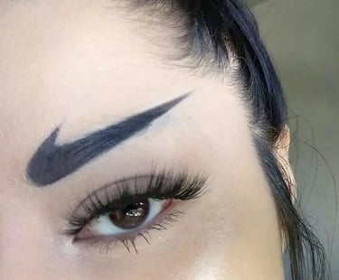 An example of unwanted permanent makeup: a woman with black Nike swoosh logos tattooed as her eyebro