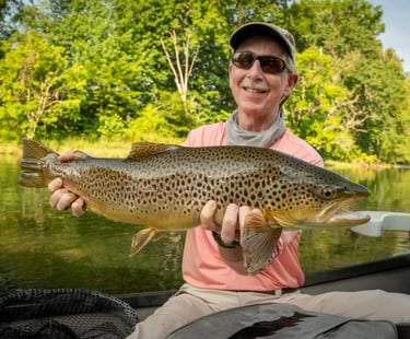 Check out Carl with this monster brown trout he caught on a low water South Holston morning.