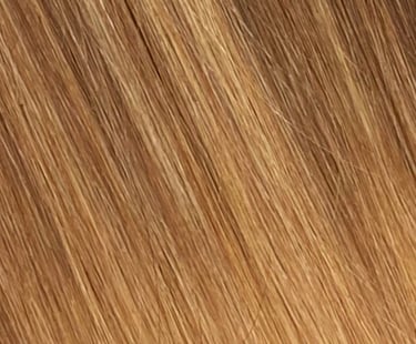Close-up of straight honey blonde hair texture with highlights and lowlights for a natural balayage look.