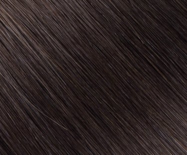 Close-up texture of dark espresso brown human hair extensions with a smooth, straight finish.