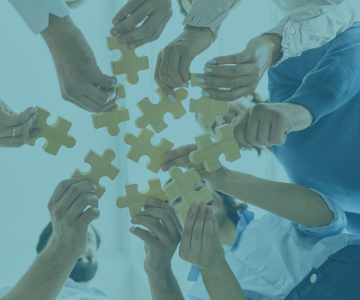 a group of people holding puzzle pieces of puzzle pieces
