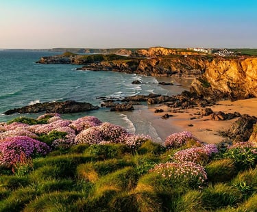 a beach with a view of a cliff and a beach