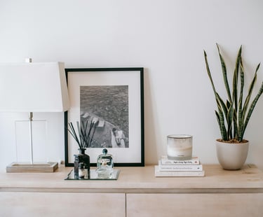 table with lamp, candle, plant and photo