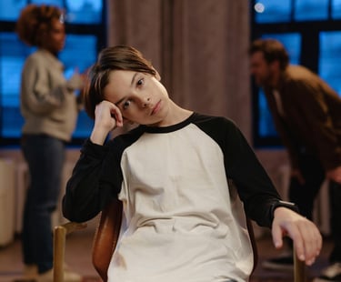 a woman sitting in a chair with a man in a chair