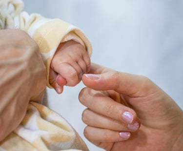 a baby's hand holding a baby's finger