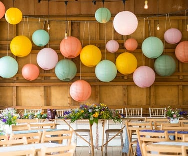 a wedding reception table with paper lanterns