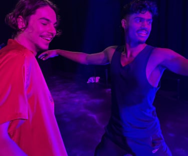 two men standing in front of a stage