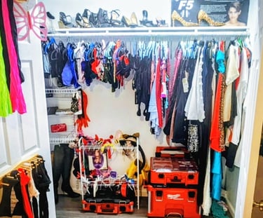 a closet with a closet full of clothes and a suitcase