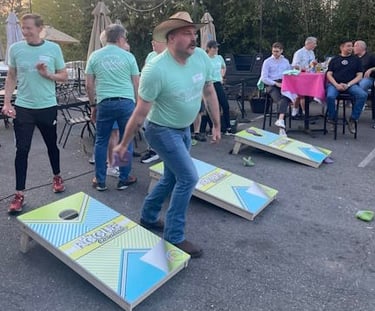 Mr. ASGRA 2026, Duke, tosses a cornhole bean bag