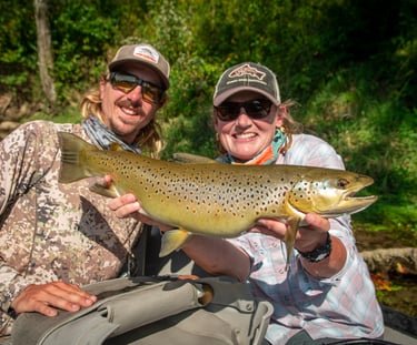 A happy client with a big brown trout in East Tennessee.