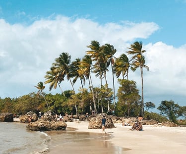 a person walking on a beach near a body of water in Morro de São Paulo, Bahia, Brazil