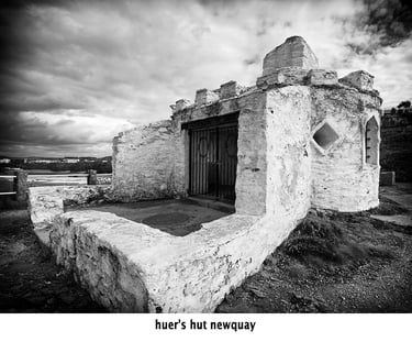 a black and white photo of the ruins of the huers hut newquay cornwall