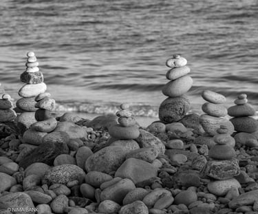 zen rocks stacked on top of one another with ocean in the background in montauk point