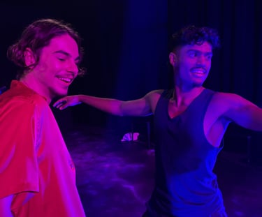 two men standing in front of a stage