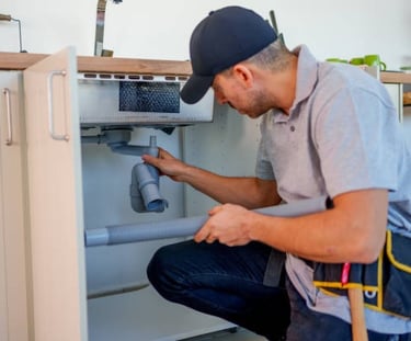 Plumber fixing a bathroom sink
