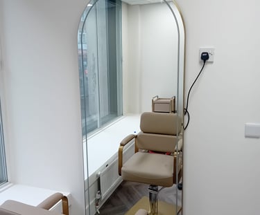 a chair with a mirror and a mirror in the background