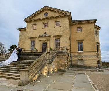 Newlywed couple posing on the stone stairs of Danson House wedding venue.