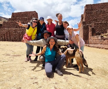 a group of people posing for a picture in the south gate of Cusco
