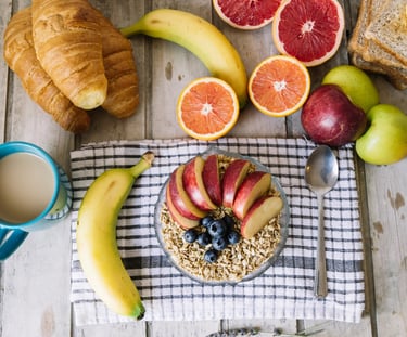 a breakfast of fruit and bread on a table