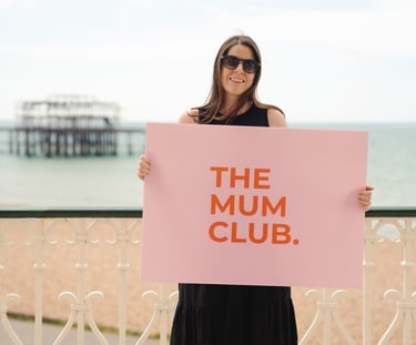 woman holding a sign on the seafront