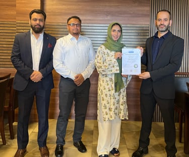 SESI Officials presenting a certificate of achievement to a female Personal trainer.