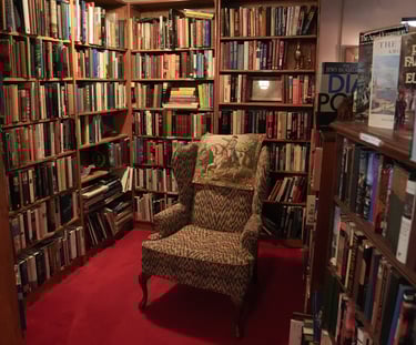 Chair in reading nook filled with used books at Chester Creek Books in Duluth, Minnesota