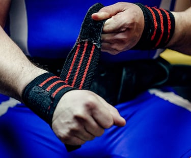 a man in a blue shirt is holding a wristband