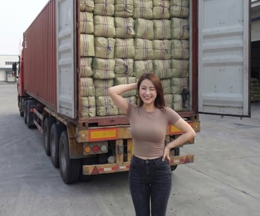 international business partner standing behind a container of dried Gracilaria seaweed, Indonesia