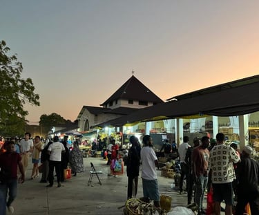Darajani Market in Stone Town Zanzibar during the evening with locals shopping for spices, fruits, and fresh seafood