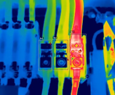 Thermal imaging scan of electrical wires showing a hot circuit breaker hotspot.